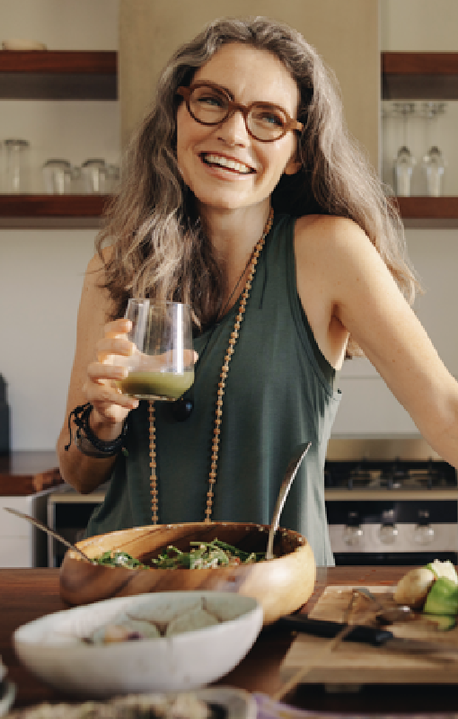 A woman smiling in her kitchen at home