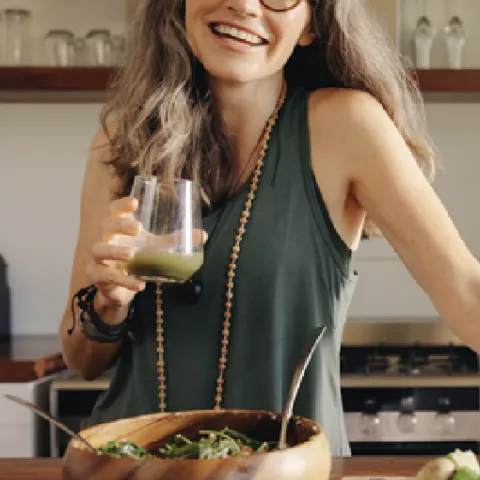 A woman smiling in her kitchen at home