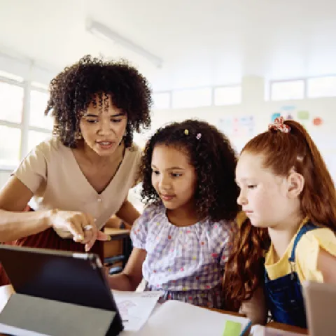 A teacher with children at school